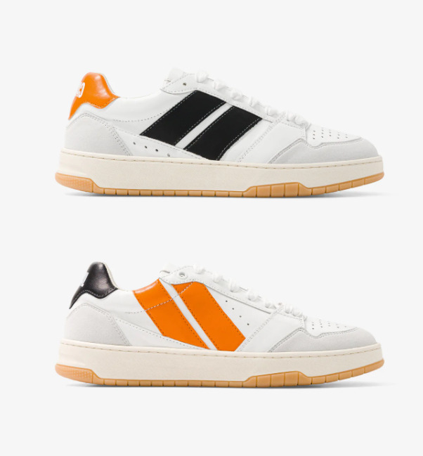 Baskets asymétriques dans les couleurs noires et orange, lacets blancs, logo brodé à l'arrière